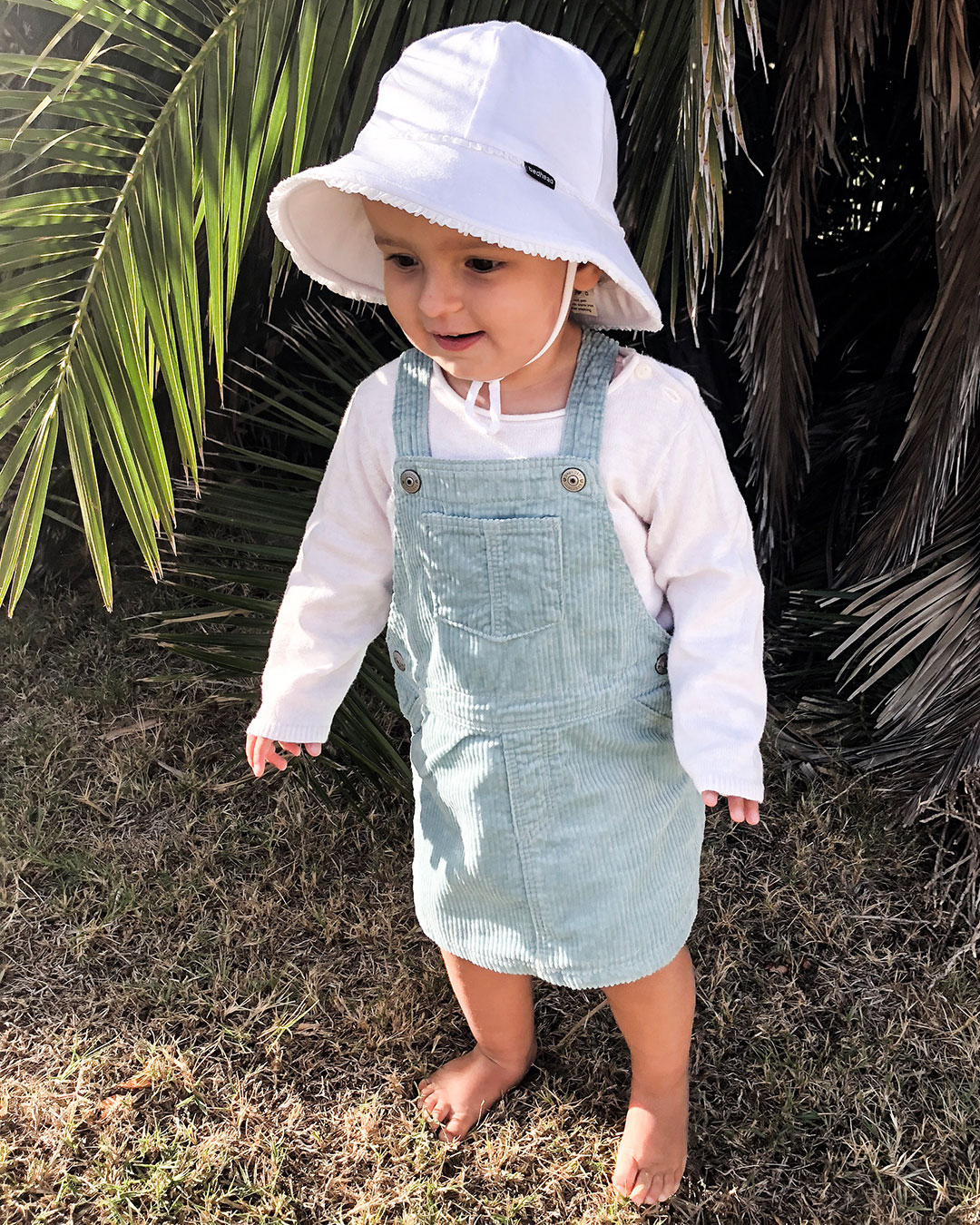 Mila wearing Bedhead baby bucket white ruffle