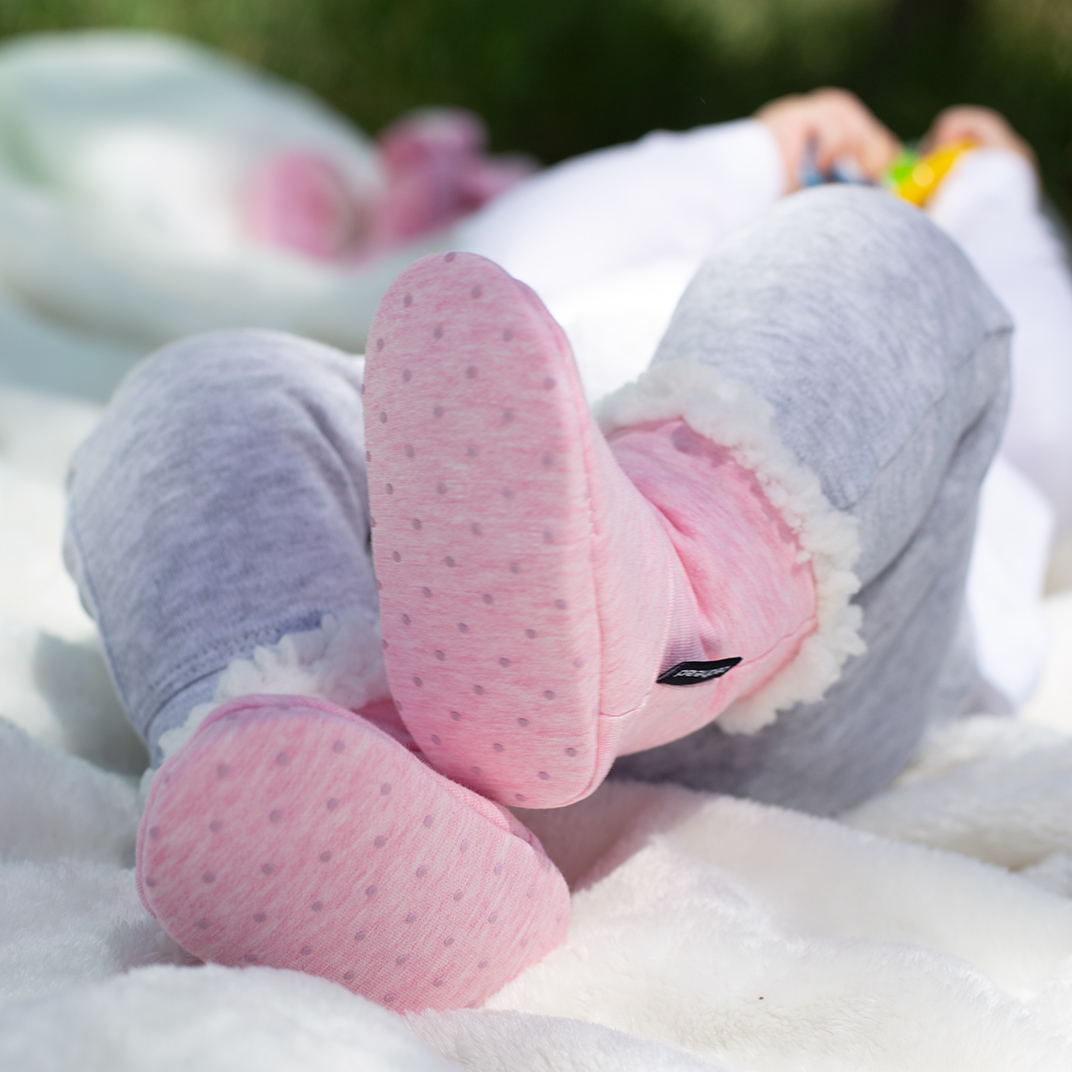 Baby wearing Bedhead booties in Baby pink marle