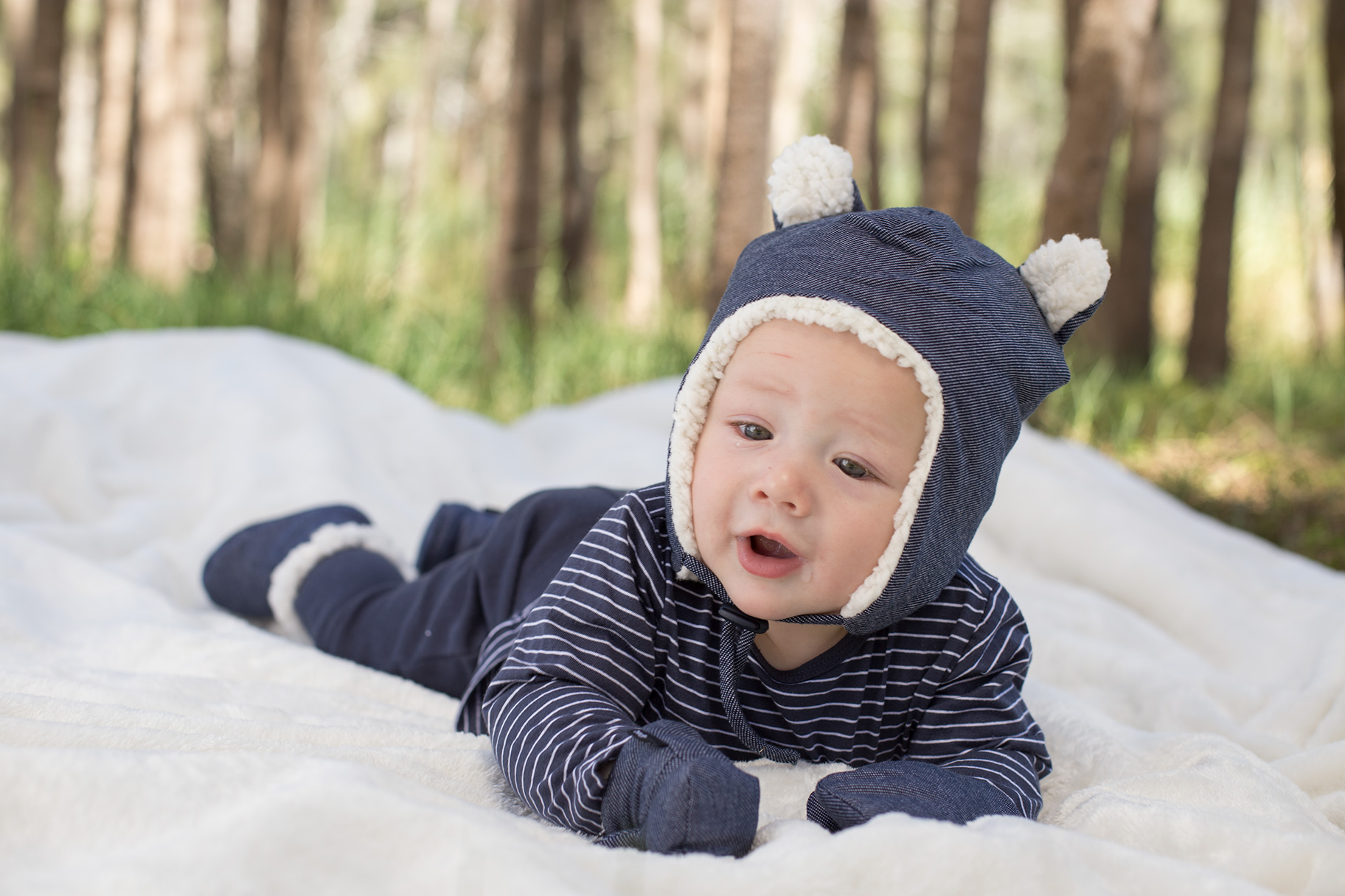 Baby wearing Bedhead beanie, mittens and booties in denim