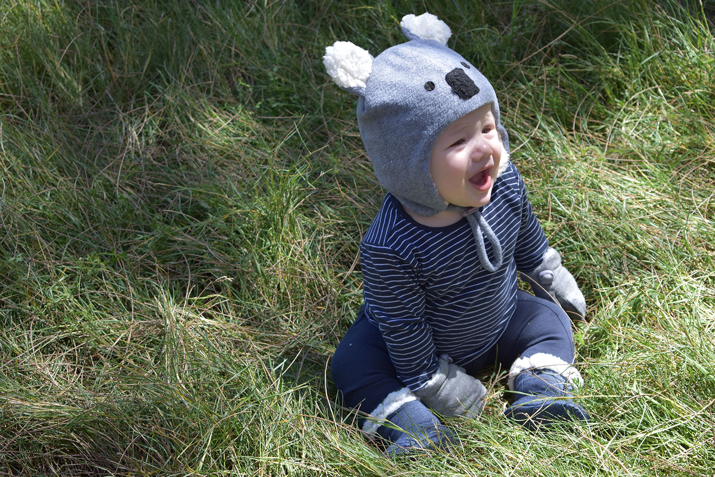 Baby wearing Bedhead koala beanie, grey mittens and denim booties