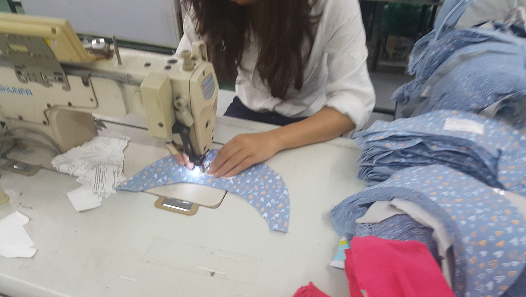 Machinist sews in Bedhead Hats 'return to' label