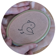 Unfolded party hat being traced over purple fabric