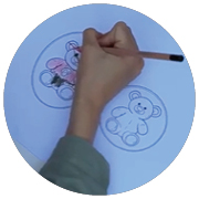 kids hand colouring in bear