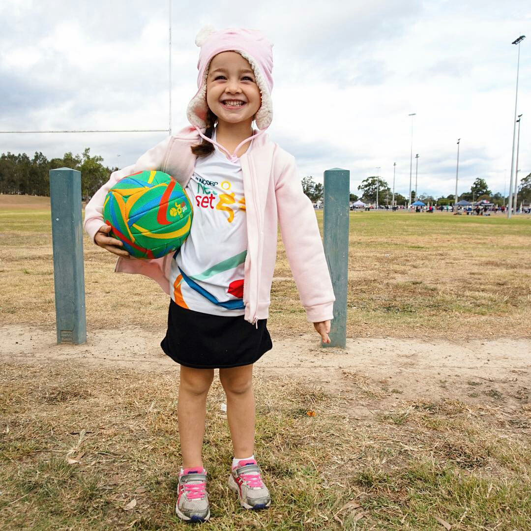 Girl in Netball uniform wearing Bedhead teddy beanie pink marle