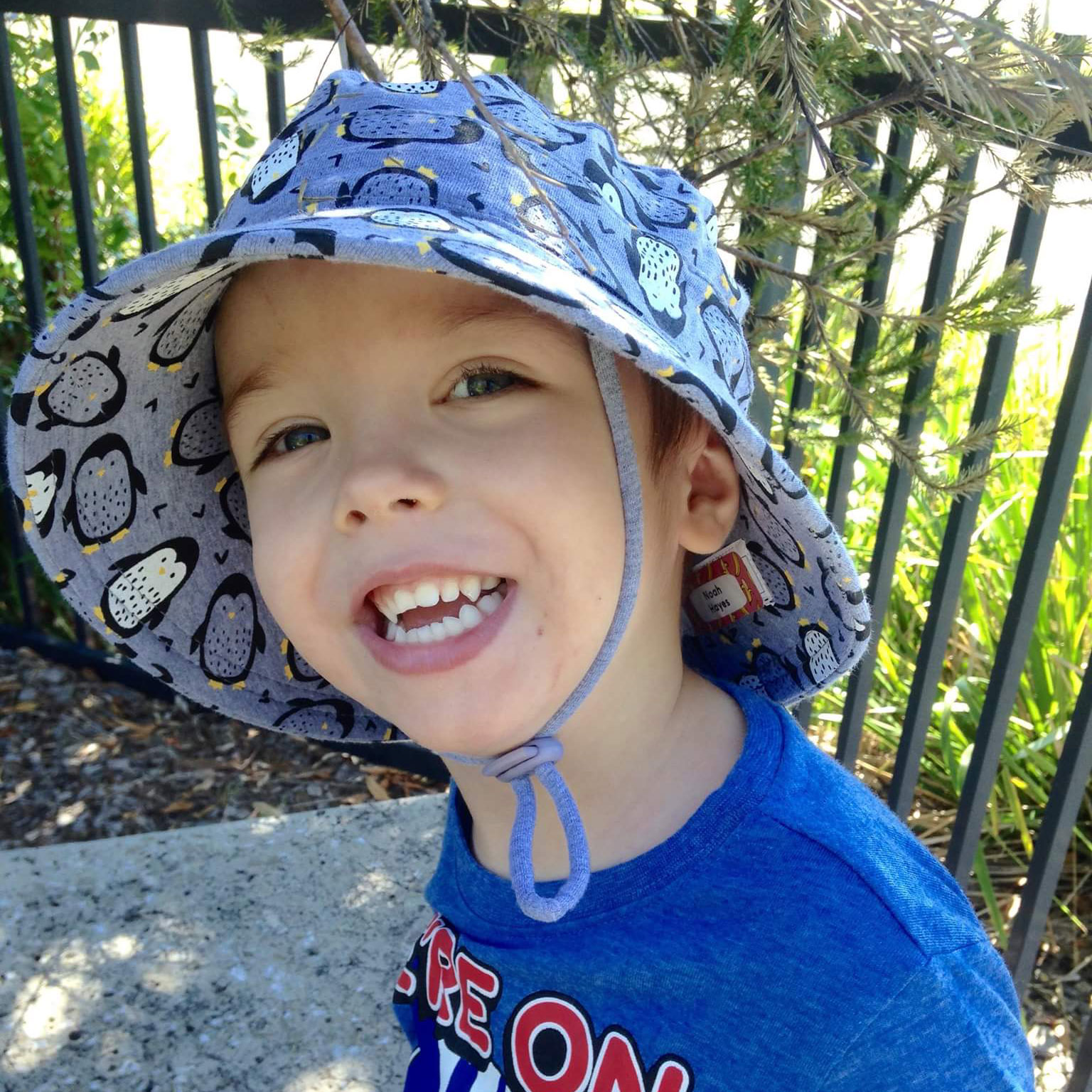 Boy wearing Bedhead Bucket Hat Penguin Print