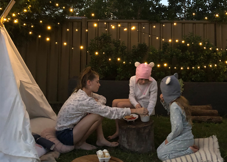 camping in the backyard with fairy lights and campfire treats